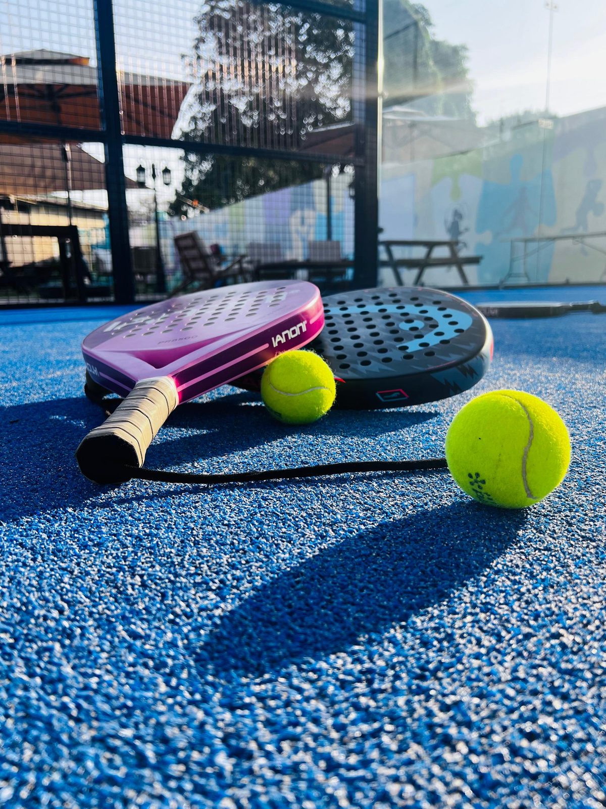 Padel rackets and balls on court