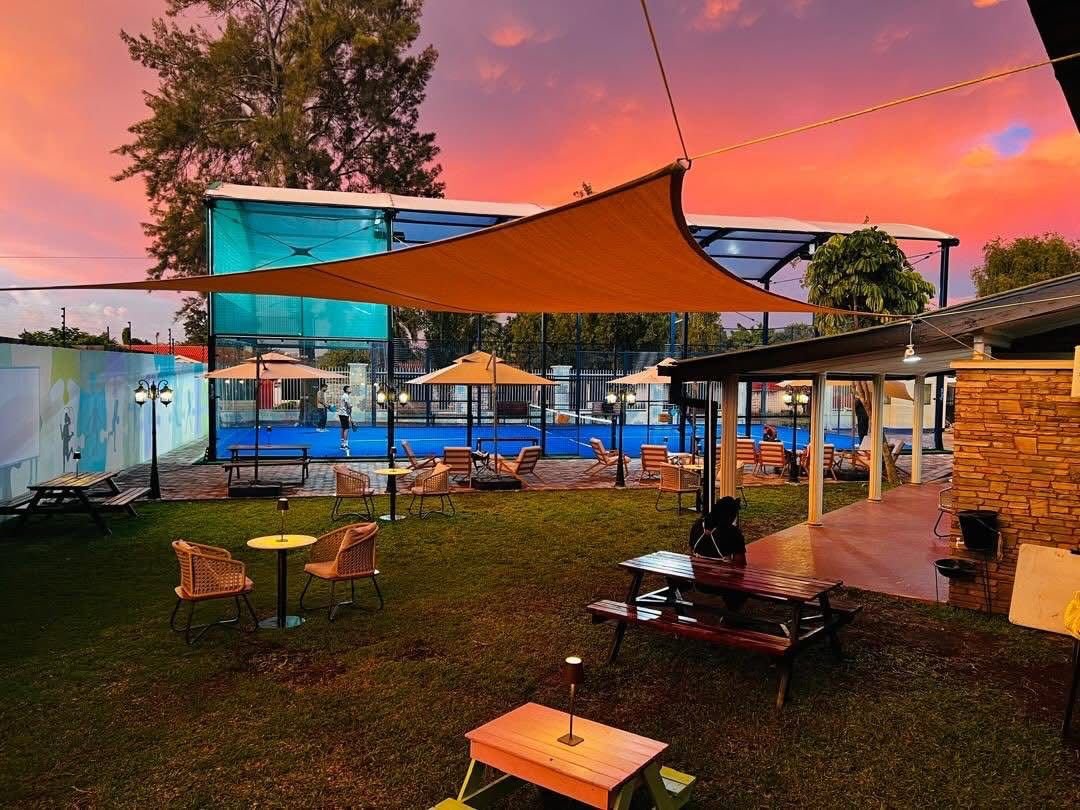 The PlayPad padel court and outdoor lounge at sunset